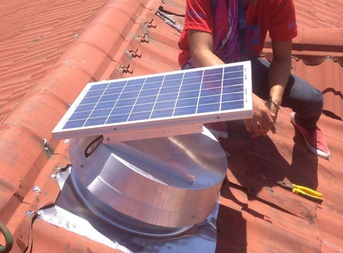Solar roof ventilator on a home roof